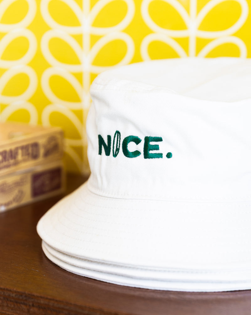 white bucket hat with green embroidery