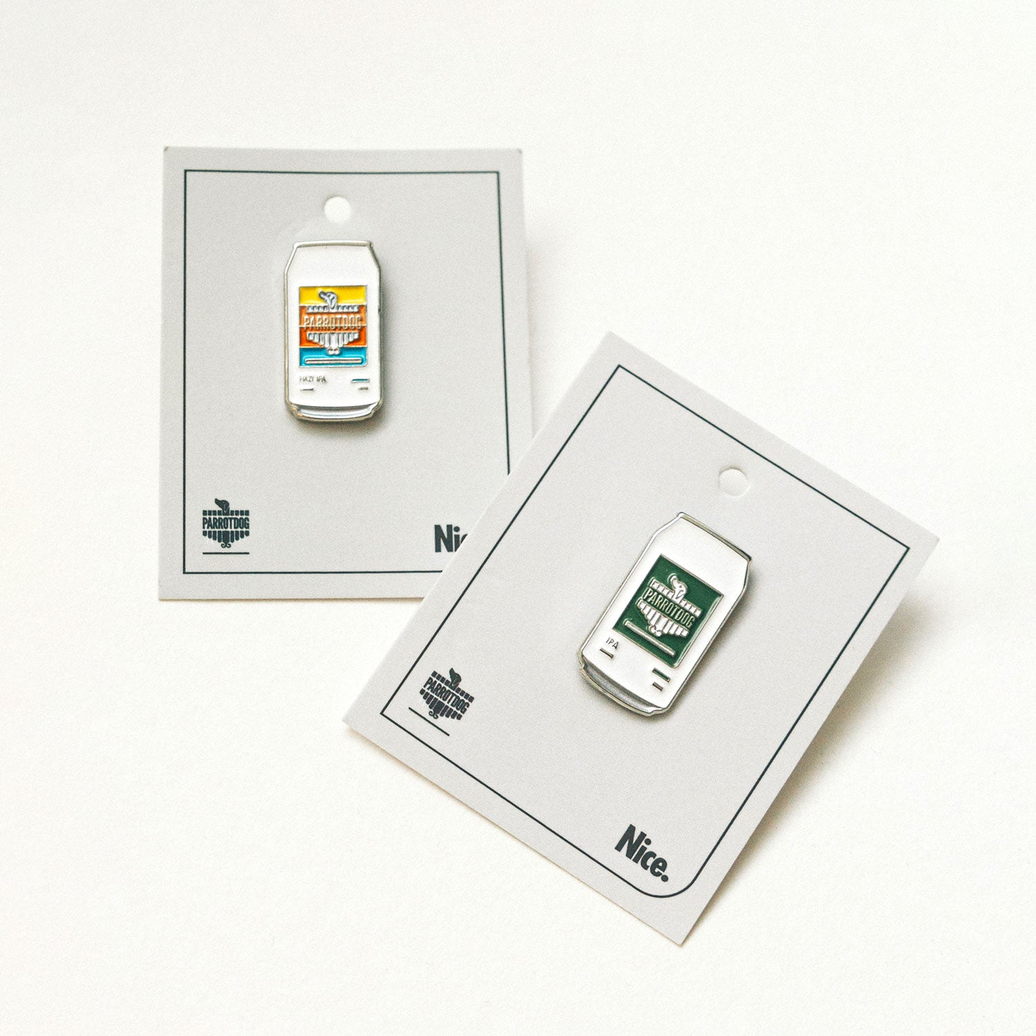 Two small beer cans on card backing